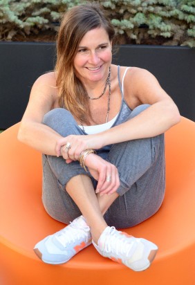 women-i-work-with-bethany-nagy-gray-jumpsuit-new-balance-sneakers-orange-chair